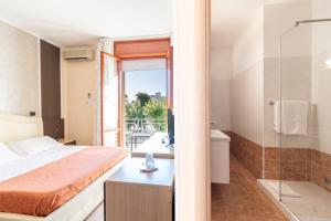 Postel nebo postele na pokoji v ubytování Hotel Gabrini