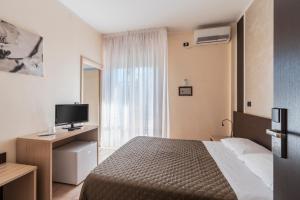 Postel nebo postele na pokoji v ubytování Hotel Gabrini