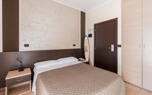 Postel nebo postele na pokoji v ubytování Hotel Gabrini