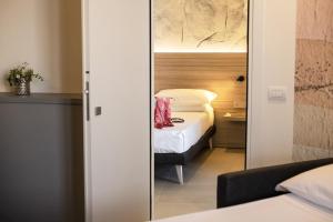 Postel nebo postele na pokoji v ubytování Hotel Cristallo