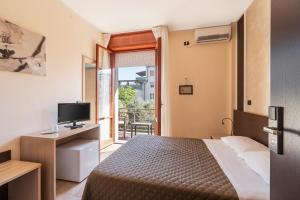 Postel nebo postele na pokoji v ubytování Hotel Gabrini