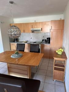 a kitchen with a wooden table and a dining room at Ferienwohnung Frank in Niederalteich