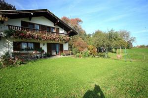 a house with a yard with a swing at Haus Klinger in Seebruck