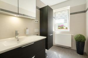 a bathroom with a sink and a window at Ferienwohnung Maisonette in Radeberg +31 photos