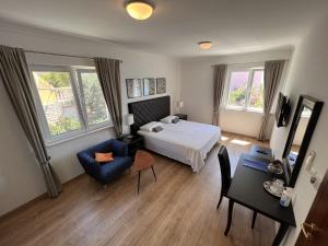 a bedroom with a bed and a table and a chair at Stone House Buljanovic in Sali