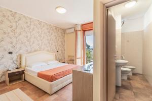 Postel nebo postele na pokoji v ubytování Hotel Gabrini