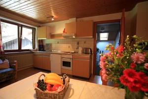 a kitchen with a basket of fruit on a table at Haus Klinger in Seebruck +4 photos