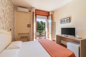 Postel nebo postele na pokoji v ubytování Hotel Gabrini