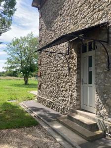 a stone building with a white door and stairs at Manoir en Pierre Chartres in Chartres +11 photos