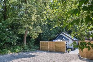 a house with a wooden fence in front of it at Ostseeoase in Boltenhagen