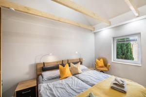 a bedroom with a large bed with yellow pillows at Ostseeoase in Boltenhagen
