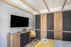 a bedroom with a bed and a tv on a wall at Ostseeoase in Boltenhagen