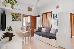 a living room with a bed and a table at Casatullio - Sant'Angelo d'Ischia in Ischia