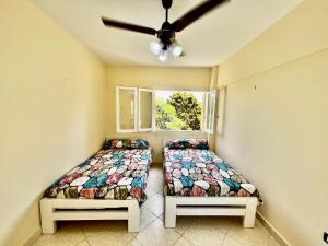 a bedroom with two beds and a window at Sea & Pool View Deluxe Chalet - Prime Spot in Badr Resort in El Alamein +31 photos