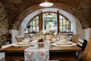 a dining room with a table with plates and bowls at Penzion Telč No. 20 in Telč