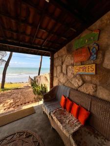 a living room with a couch and a view of the beach at Casa da Peroba Sol - Pé na Areia - Praia da Peroba - Icapuí in Icapuí