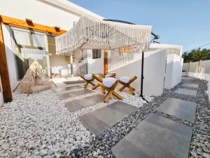 a patio with two benches and a chandelier at Meteora Superior Collection Villas III in Kalabaka