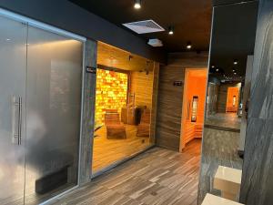 a lobby with a glass door and a room with chairs at Baltic Comfort SPA Apartment - FREE swimming pool, saunas & fitness - Kasprowicza 20 in Kołobrzeg