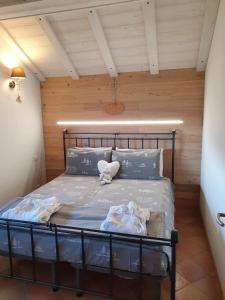 a bedroom with a black bed in a room at Baita casapendola in Marter di Roncegno