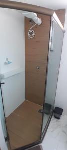a bathroom with a shower with a glass door at Loft da Prainha in Arraial do Cabo