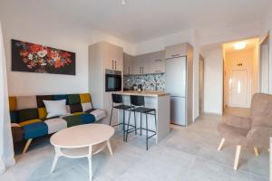 a kitchen and living room with a couch and a table at Sandra Seaview Suites in Neos Marmaras