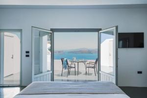 a bedroom with a view of the ocean at Santonero in Akrotiri