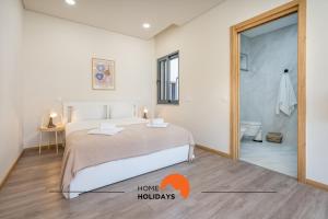 a bedroom with a bed and a bathroom with a shower at #234 Serenity Refuge w Balcony and Pool in Páteo