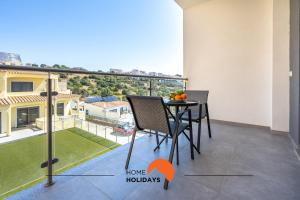 a balcony with a table and a view of a house at #234 Serenity Refuge w Balcony and Pool in Páteo