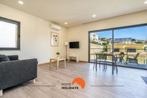 a living room with a couch and a table at #234 Serenity Refuge w Balcony and Pool in Páteo