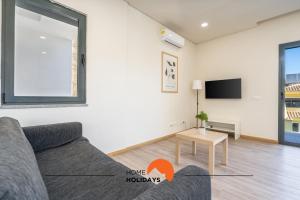 a living room with a couch and a tv at #234 Serenity Refuge w Balcony and Pool in Páteo +40 photos