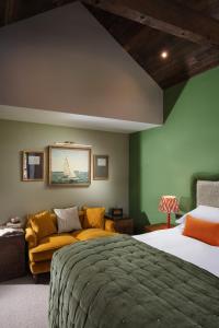 a bedroom with a bed and a couch at Pier House in St Austell +52 photos