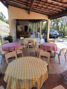 a group of tables and chairs with checkered tables at Chácara casa da sogra in Santana de Parnaíba
