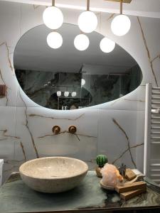 a bathroom with a stone sink and a mirror at House maria elenι in Skala Kallirachis +45 photos