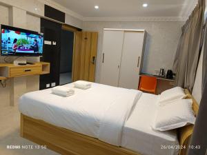 Letto o letti in una camera di Arasan Residency