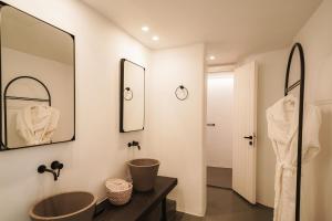 a bathroom with two sinks and a mirror at Santonero in Akrotiri
