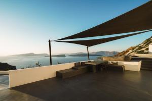a patio with a table and a view of the water at Santonero in Akrotiri