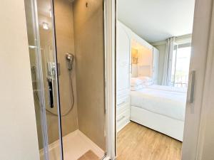 a small bathroom with a shower and a bed at Hôtel de Provence in Cannes