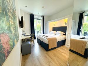 a hotel room with a bed and a desk at Hôtel de Provence in Cannes
