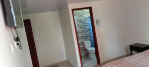 a room with a bathroom with a toilet and a doorway at Hotel Alta Vista Campestre in Tibasosa +41 photos