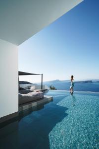 a little girl is standing in a swimming pool at Santonero in Akrotiri