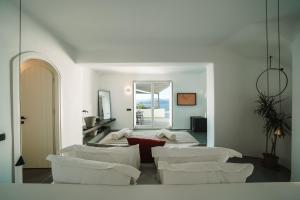 a living room with white chairs and a mirror at Santonero in Akrotiri +37 photos