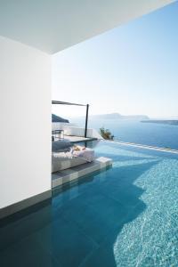 a bedroom with a bed next to a swimming pool at Santonero in Akrotiri