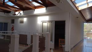 a room with white walls and wooden ceilings at Departamentos MR in Villa Elisa
