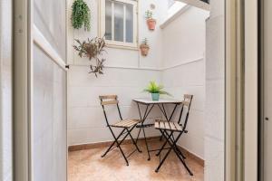 a small table and two chairs in a room at Al Duomo in Brindisi