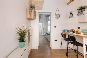 a kitchen with a counter and stools in a room at Al Duomo in Brindisi