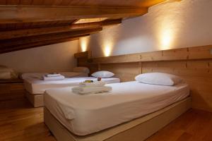two twin beds in a room with wooden walls at Résidence Androsace 53 - Happy Rentals in Chamonix-Mont-Blanc +21 photos