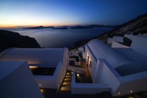 a view of the ocean at night with white buildings at Santonero in Akrotiri