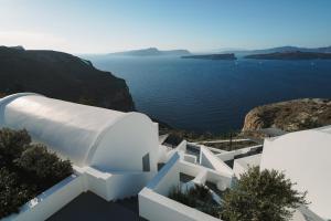 a white building with a view of the water at Santonero in Akrotiri