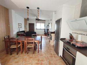 a kitchen and dining room with a table and chairs at La Moralea in Cáñar