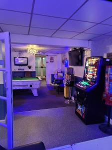 a gaming room with a video game console and a pool table at The Merlin Hotel in Blackpool